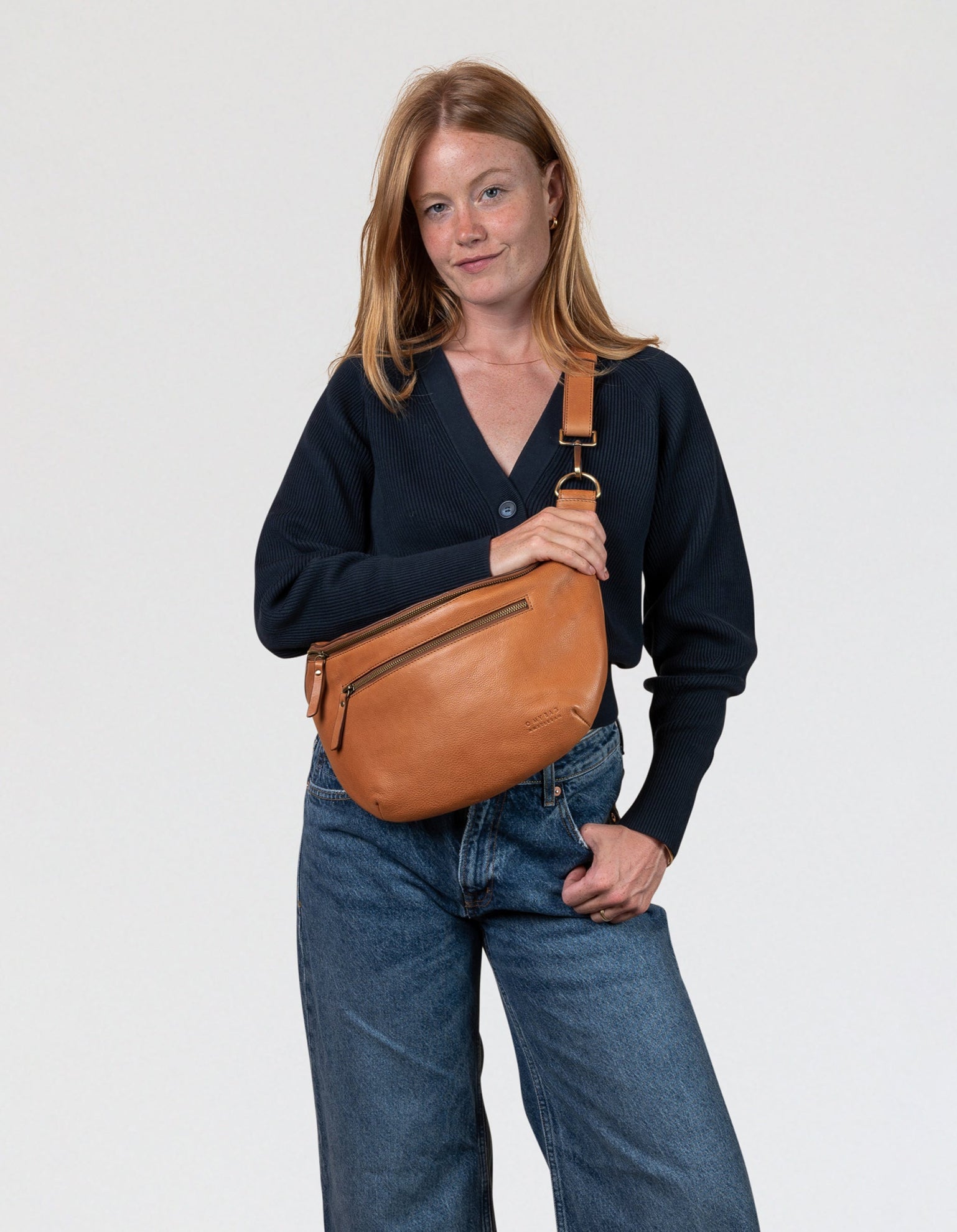 Drew Maxi in wild oak leather ft. adjustable leather strap. Female model product image.