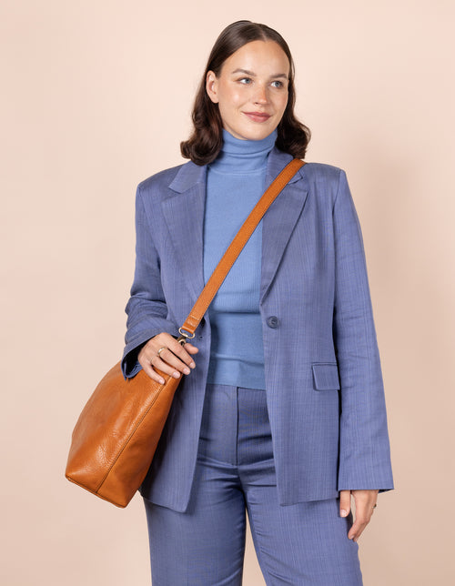 Olivia Cognac Stromboli Leather. Large rectangular everyday bag for women. Model image.