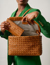 Campaign image - model with woven Pau's Pouch Wallet and Woven Kenzie bag