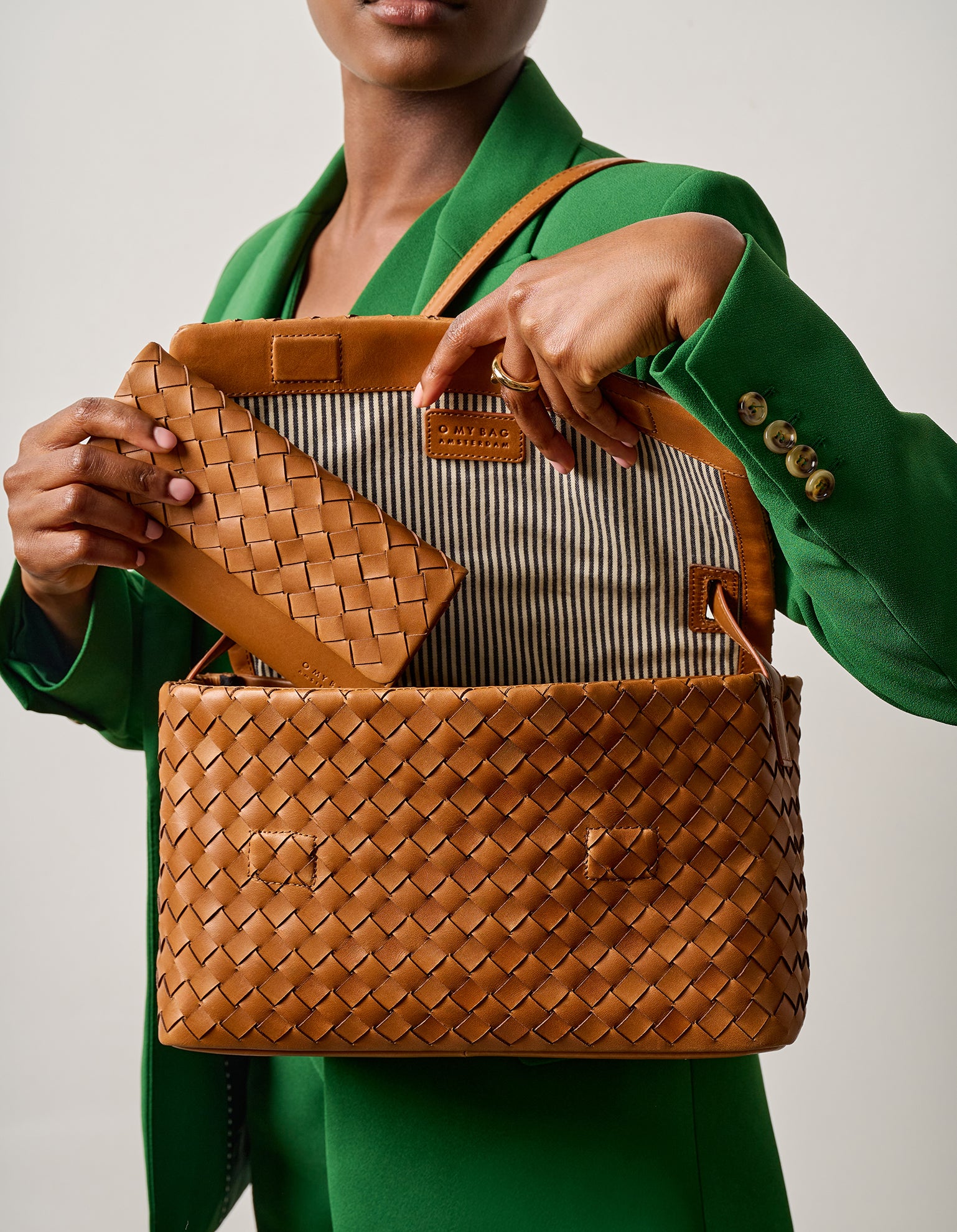 Campaign image - model with woven Pau's Pouch Wallet and Woven Kenzie bag