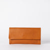 Pau Pouch Cognac Leather women’s purse. Rectangular shaped fold over wallet. Front model image.