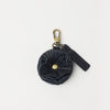 Blue keychain with decorative element on a white background