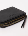 black wallet laid down on white background - close up of open zipper and zipper handle