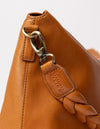 cognac bag on white background - close up of strap carabiner hooked on bag