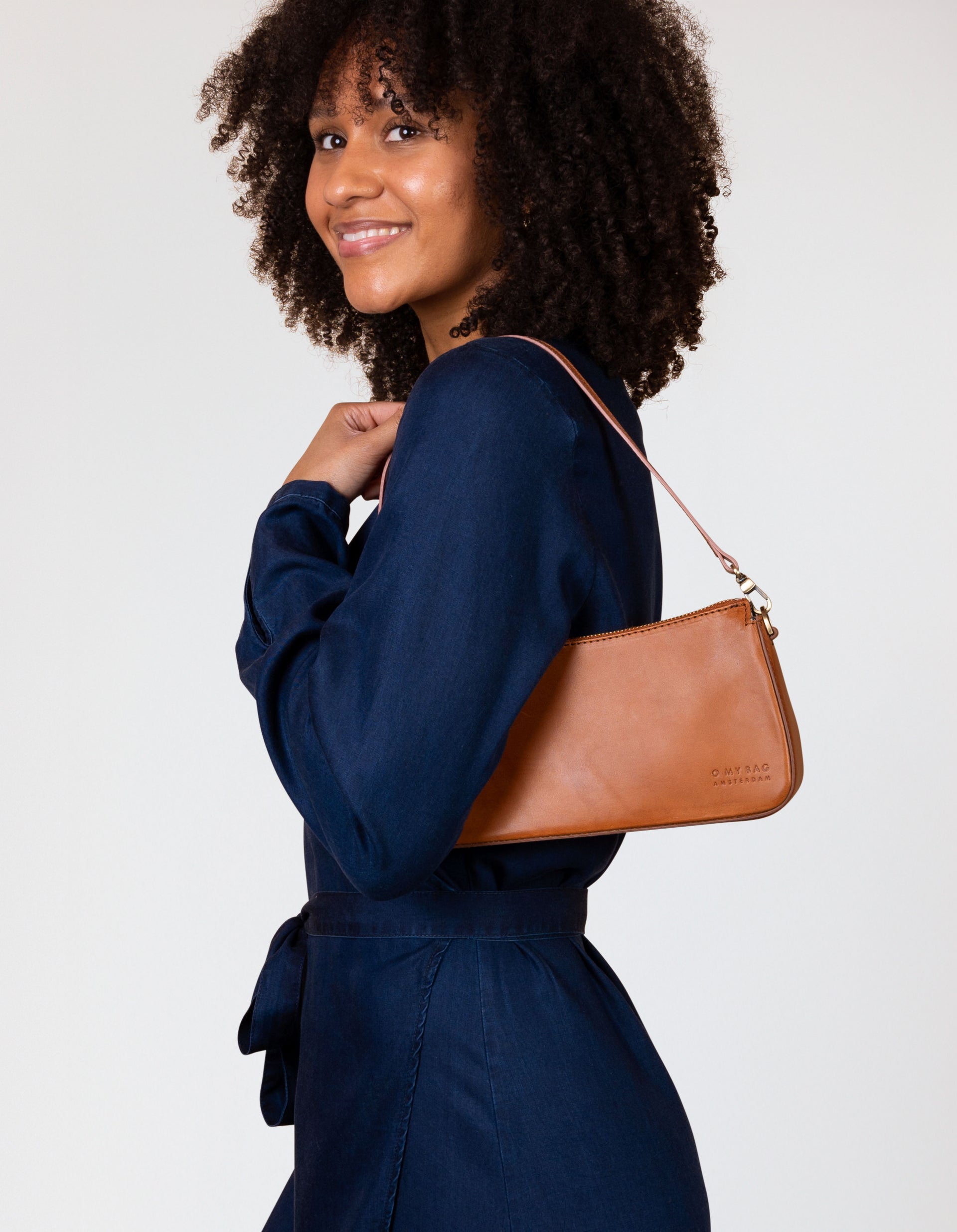 Taylor baguette bag in cognac - model product image with a short strap