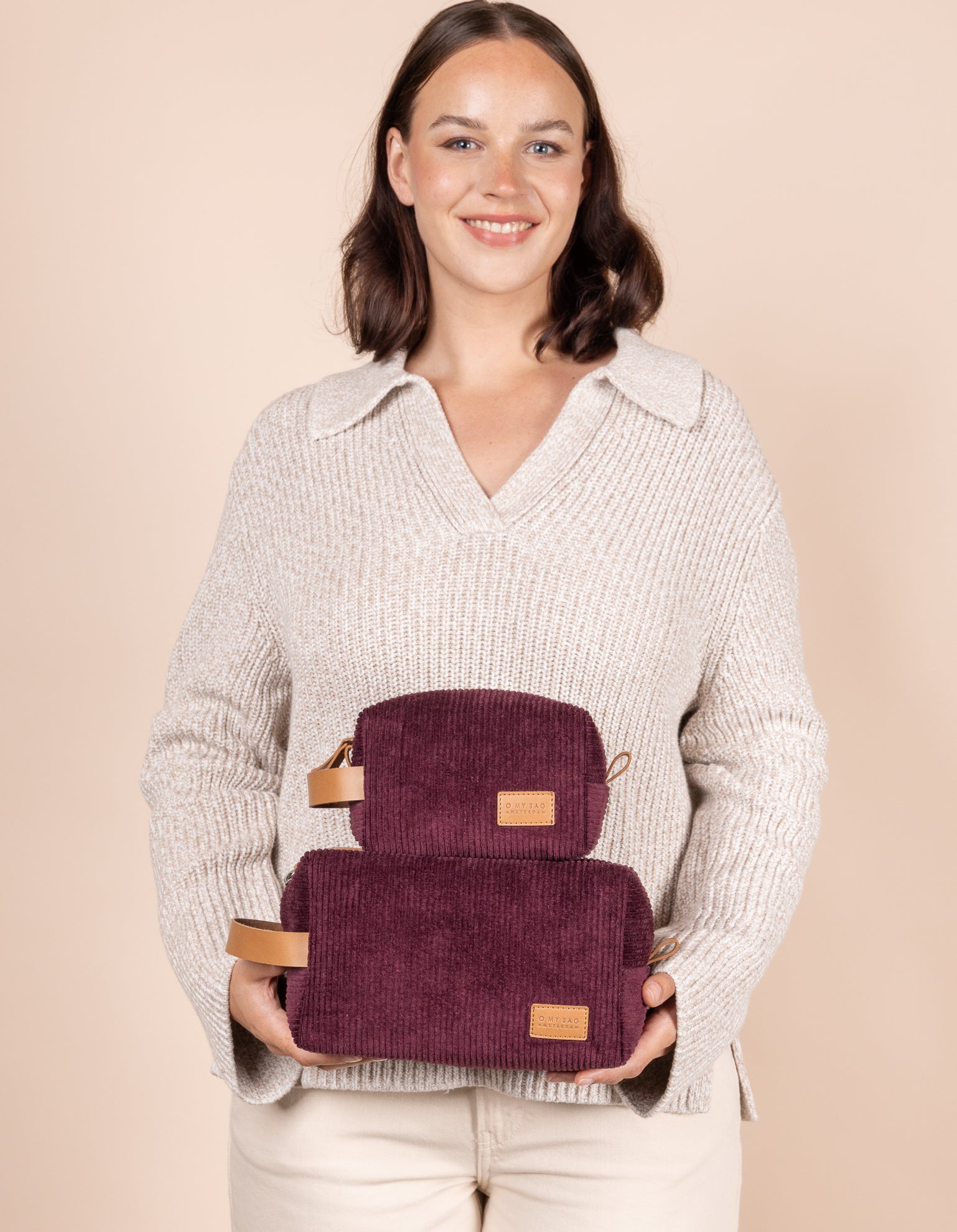 Model holding both Ted Travel cases in corduroy