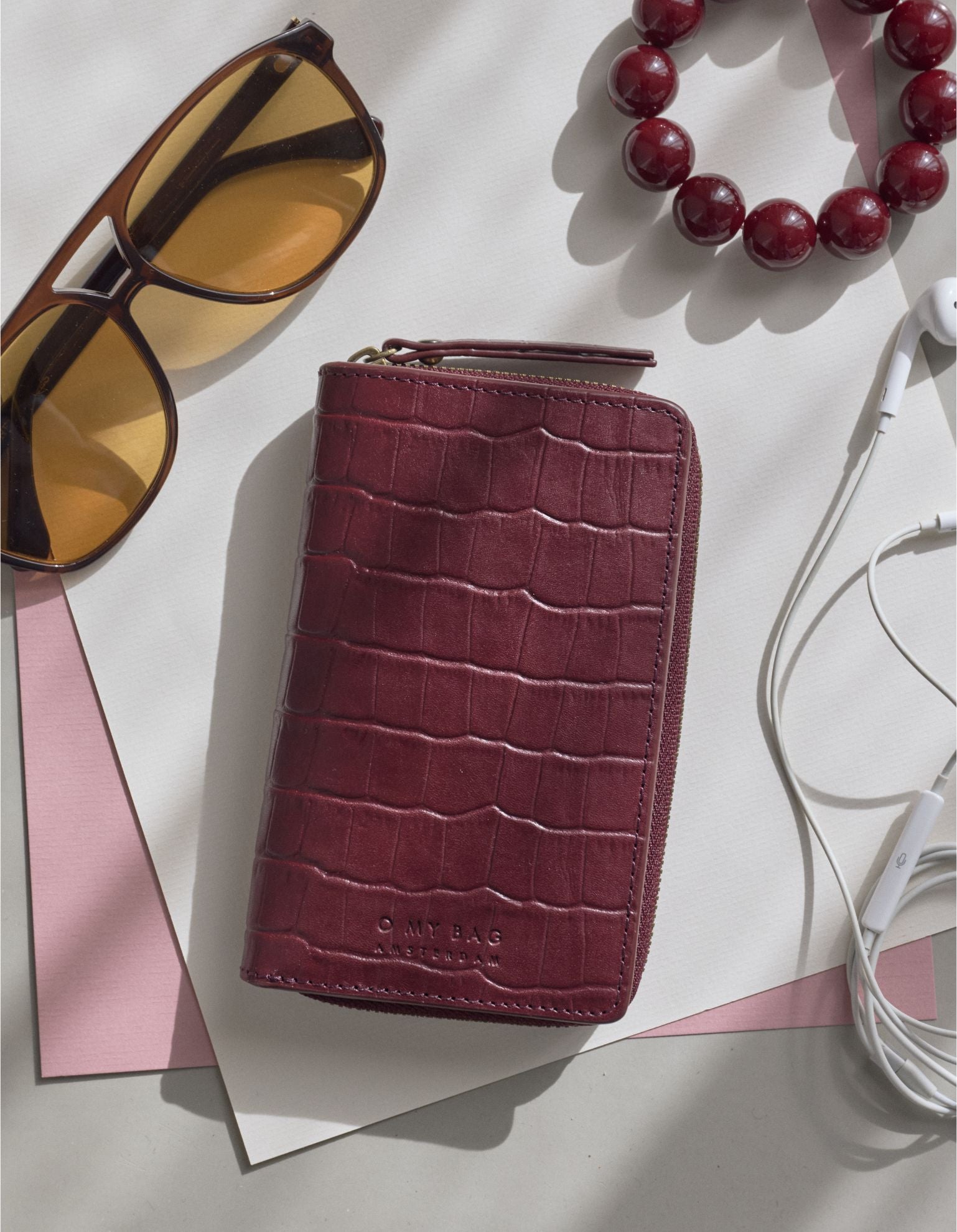 Jett Wallet - Dark Cherry Croco Print Leather. Lifestyle Product Image.