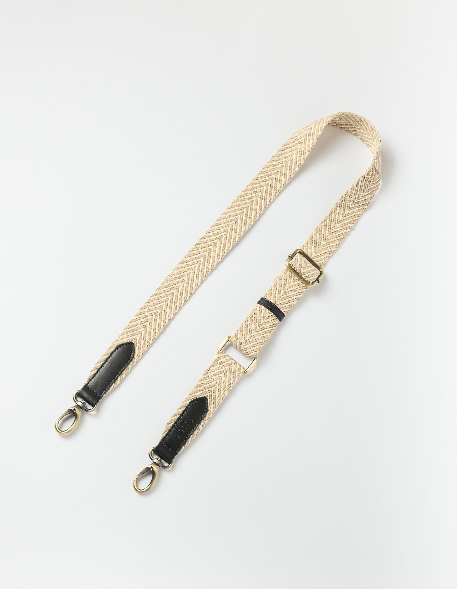 Organic cotton webbing strap in sand with black leather - Product image