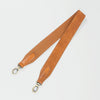 Reversible cross body strap - cognac classic leather - image of strap laid flat