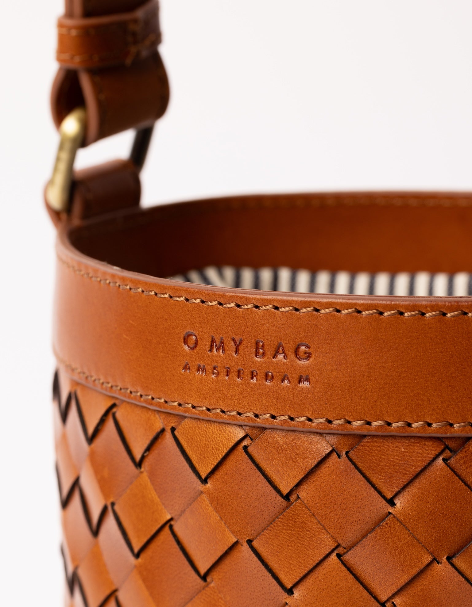 Zola woven leather bucket bag - close-up of logo