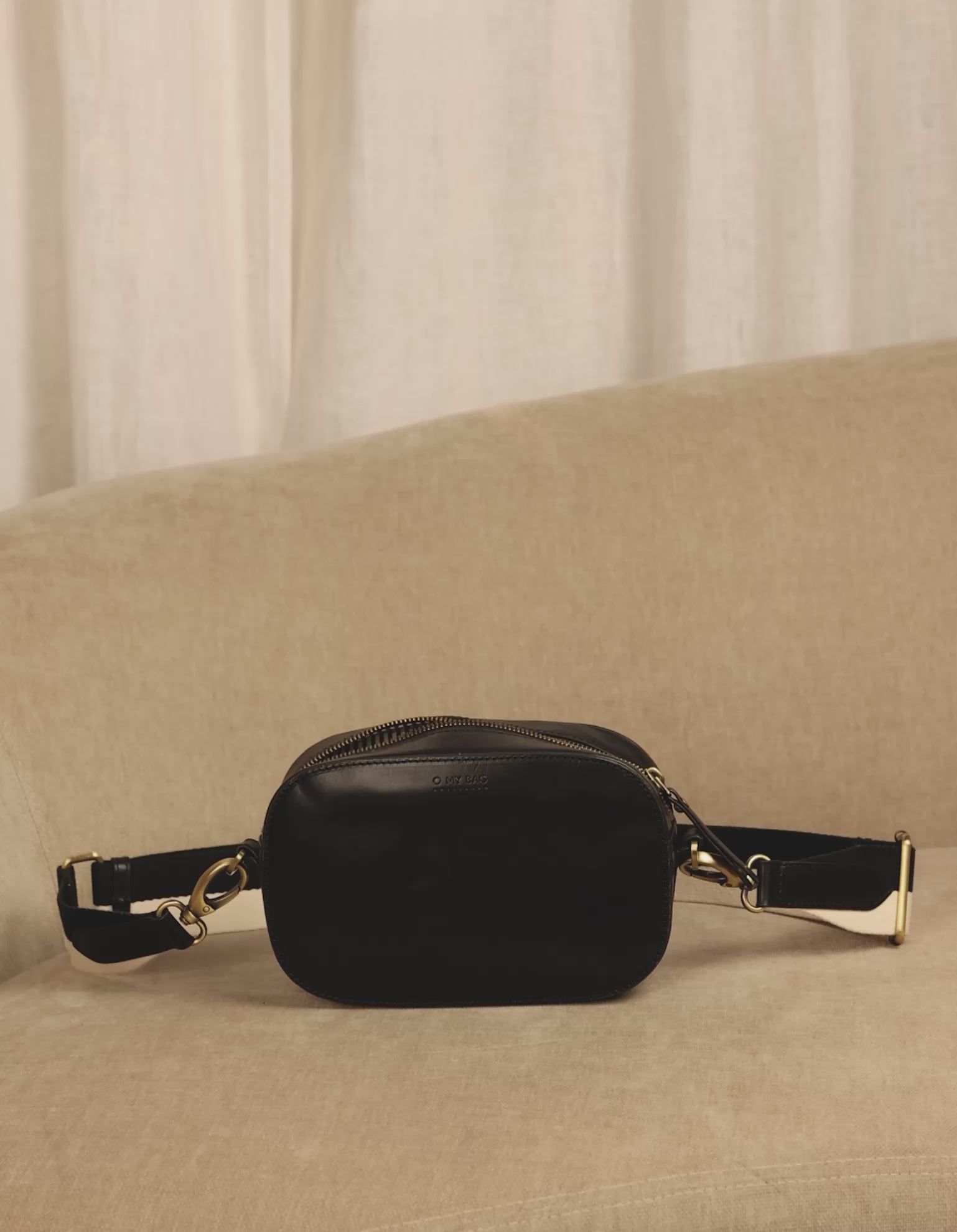 Inside bag video of Maya black classic leather crossbody bag with adjustable leather strap