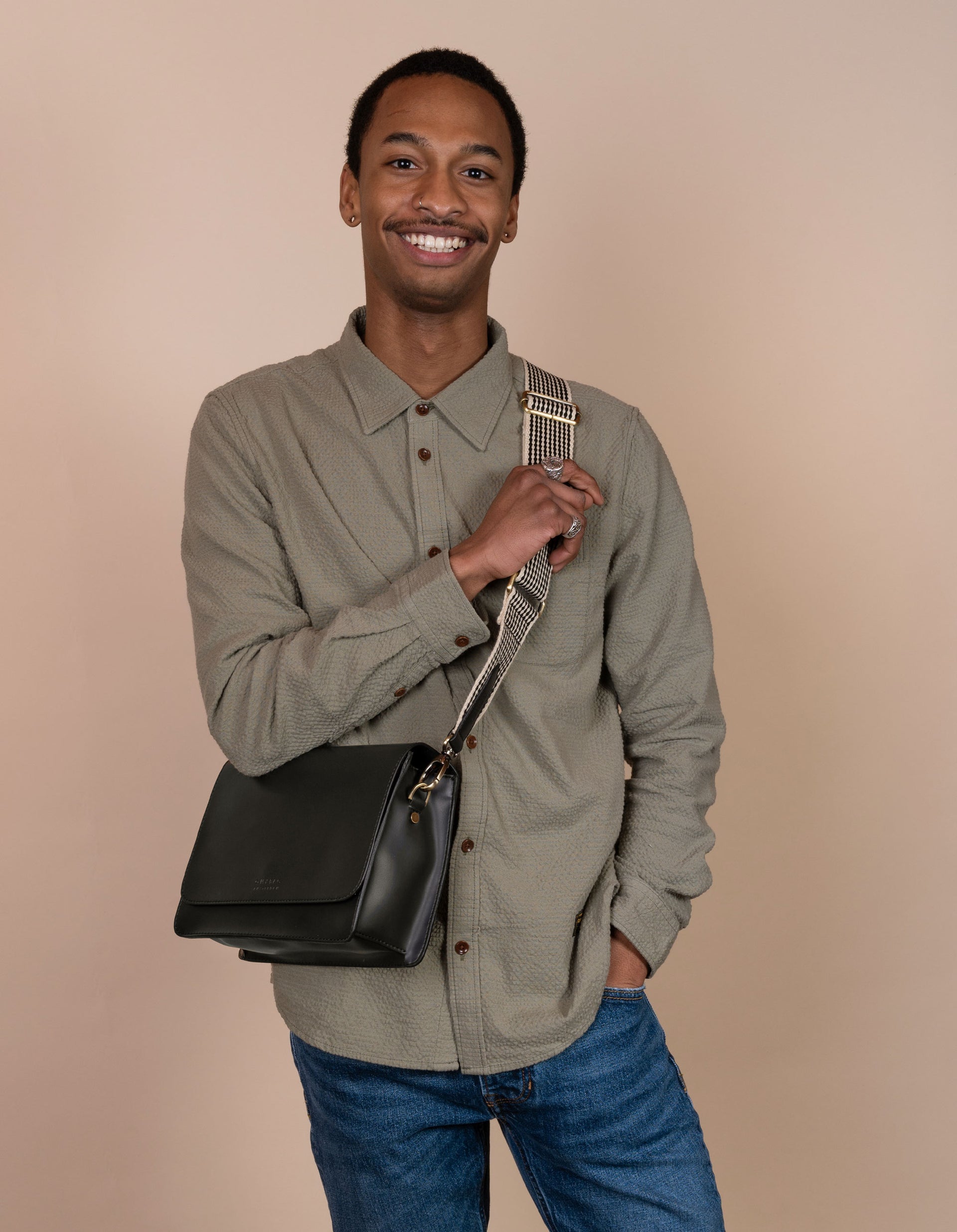 Audrey in black apple leather. Male model image with plain strap.