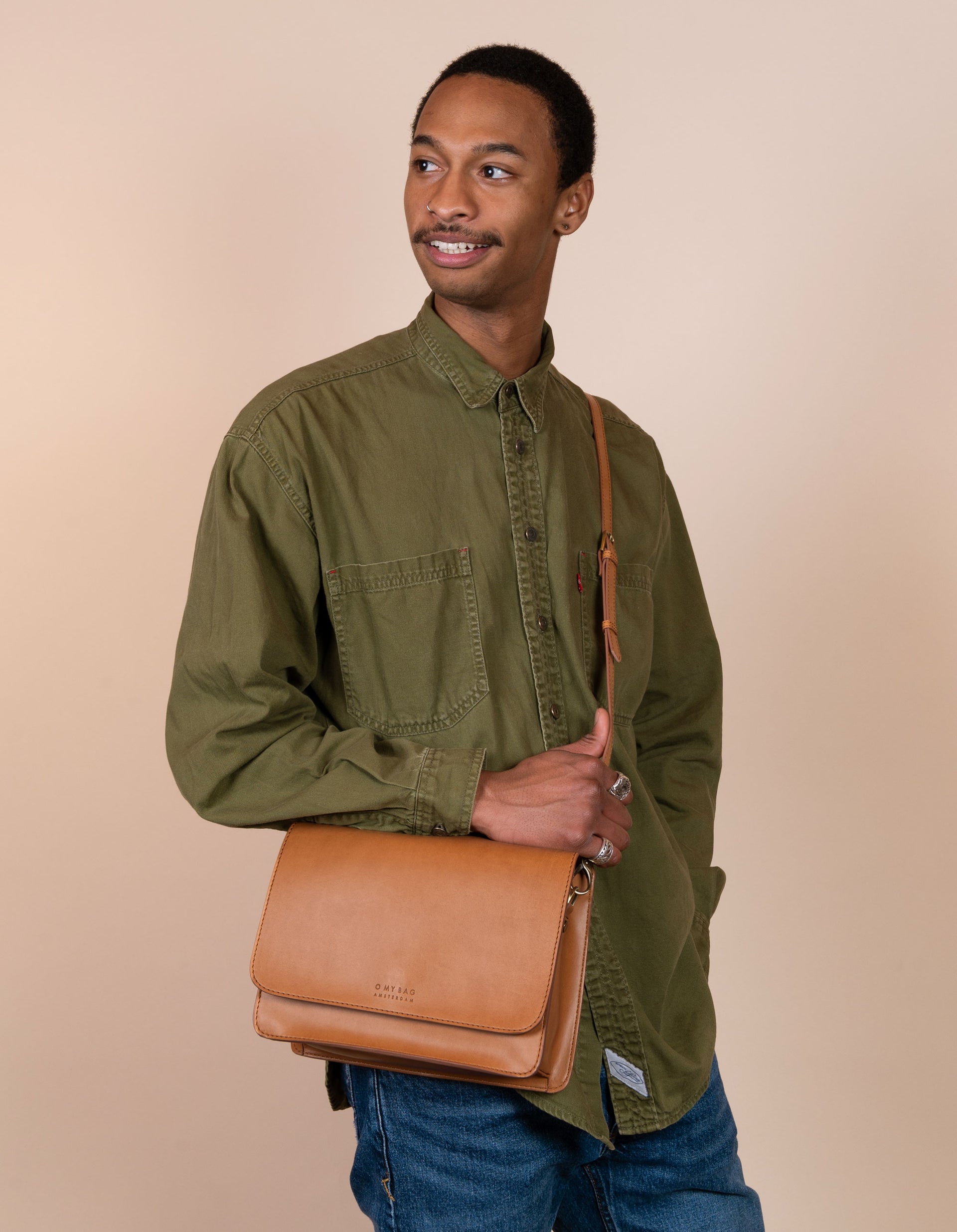 Male model with Audrey in cognac apple leather and leather strap.