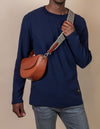 Ava in Cognac Classic Leather. Male model Image with checkered webbing  strap.
