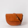 Ava saddle bag with a leather crossbody strap. Front product image - cognac classic leather.