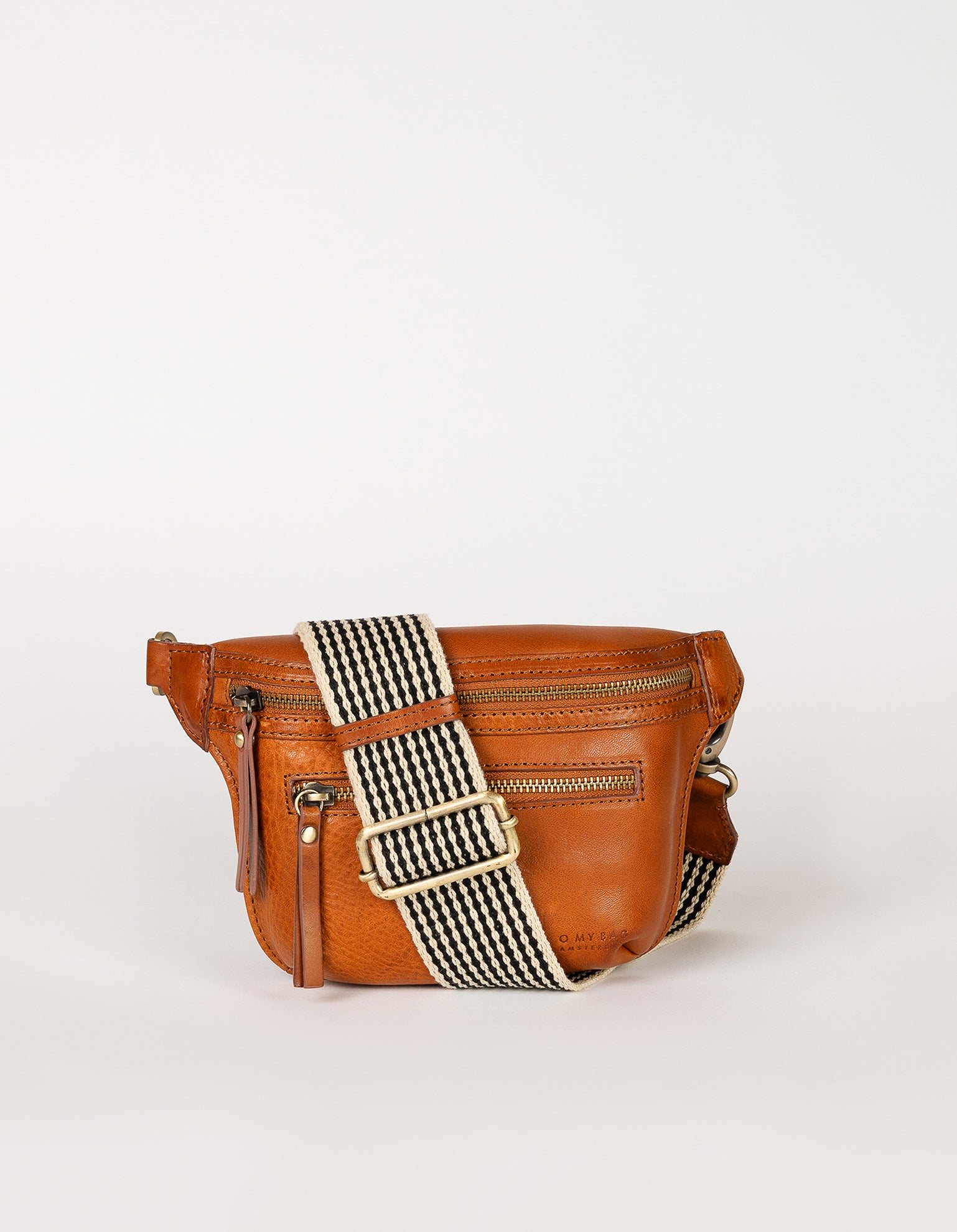 Cognac Leather womens fanny pack. Square shape with an adjustable strap. Front product image.