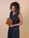 Cosmetics Bag in cognac classic leather. Model product image.