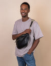 Drew Maxi Bum Bag in Black Soft Grain Leather - Model Image, front view with the checkered webbing strap