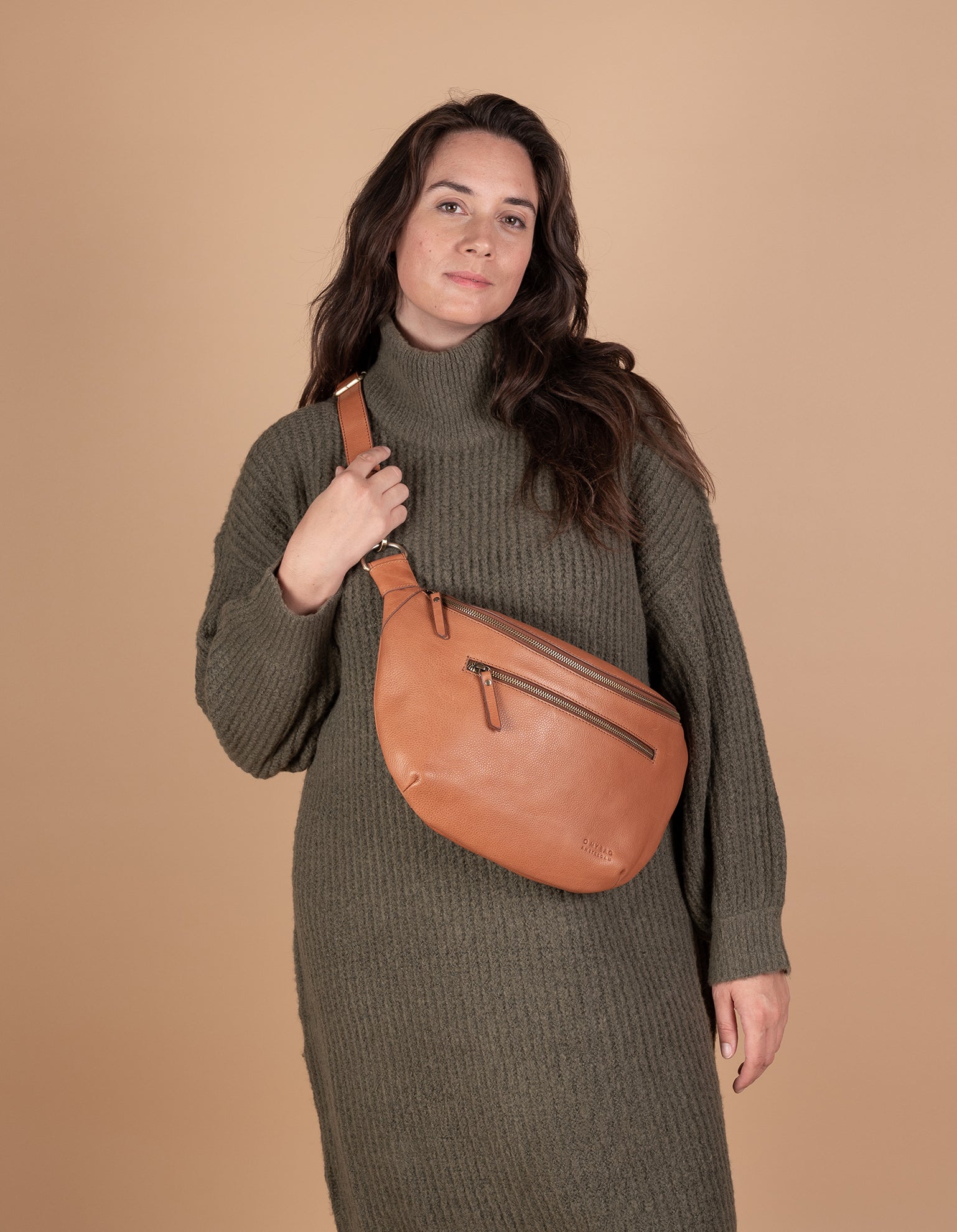 Drew Maxi in wild oak leather ft. adjustable leather strap. Female model product image.