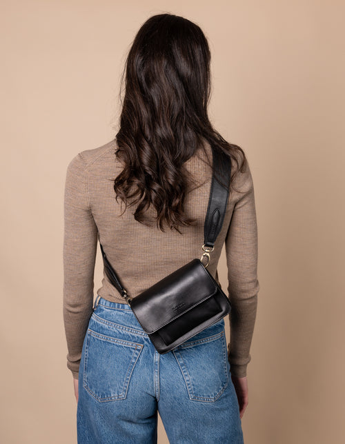 Harper Mini Black Leather crossbody handbag. Model product image