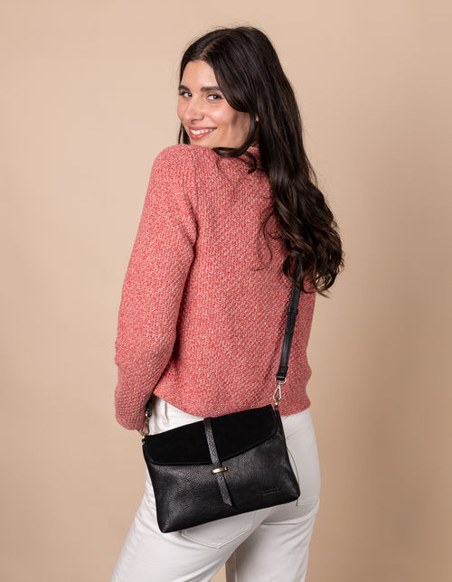 Black Soft Grain & Suede leather womens handbag. Square shape with an adjustable strap. Model image