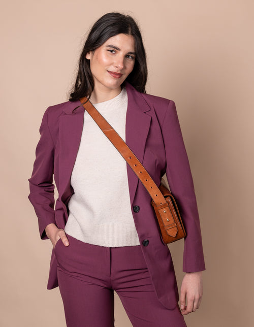 Cognac Baguette Leather womens handbag. Square shape with an adjustable strap. Model image