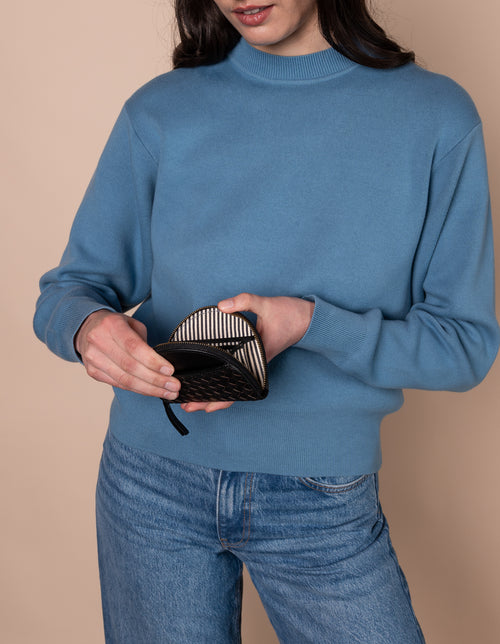 Model with Laura coin purse in black woven classic leather