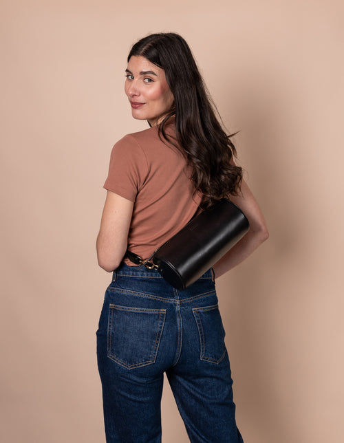 Model with Izzy bag in black classic leather