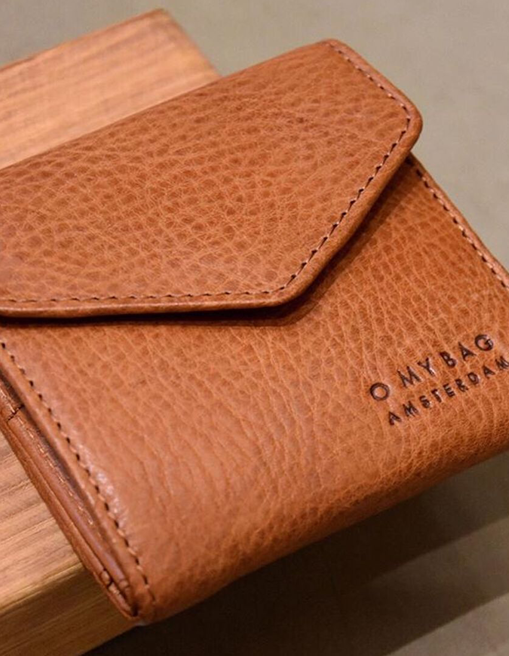 Cognac wallet. Square Envelope shape. Lifestyle product image.
