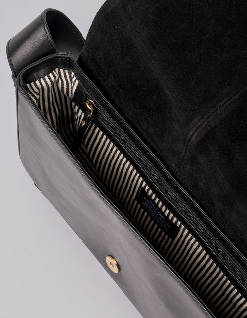 Black Baguette Leather womens handbag. Square shape with an adjustable strap. Inside product image.