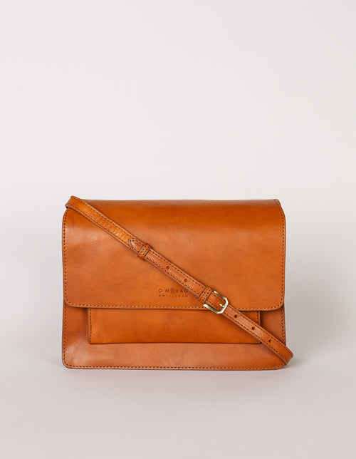 Harper Cognac Leather crossbody handbag. Front product image. Adjustable leather strap.