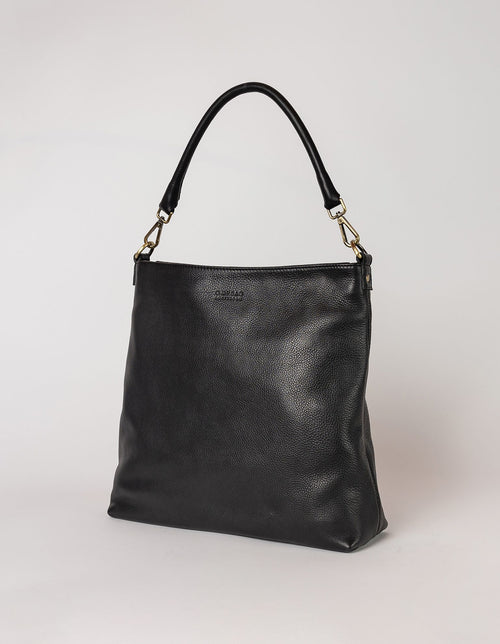 Black Leather shopper bag. Square shape with an adjustable and removable strap. Side product image.