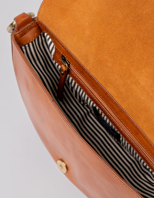Laura Bag Cognac Classic Leather. Round moon shape crossbody bag for women. Inside product image.