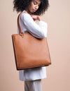Mila Long Handle Cognac Classic Leather. Large rectangular shopper for women. Model image.