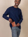 Passport holder in cognac classic leather. Male model product image.