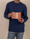 Passport holder in cognac classic leather. Male model product image.