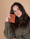 Passport holder in cognac classic leather. Model product image.
