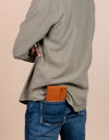Pau Pouch Cognac Leather purse. Rectangular shaped fold over wallet. Male model image