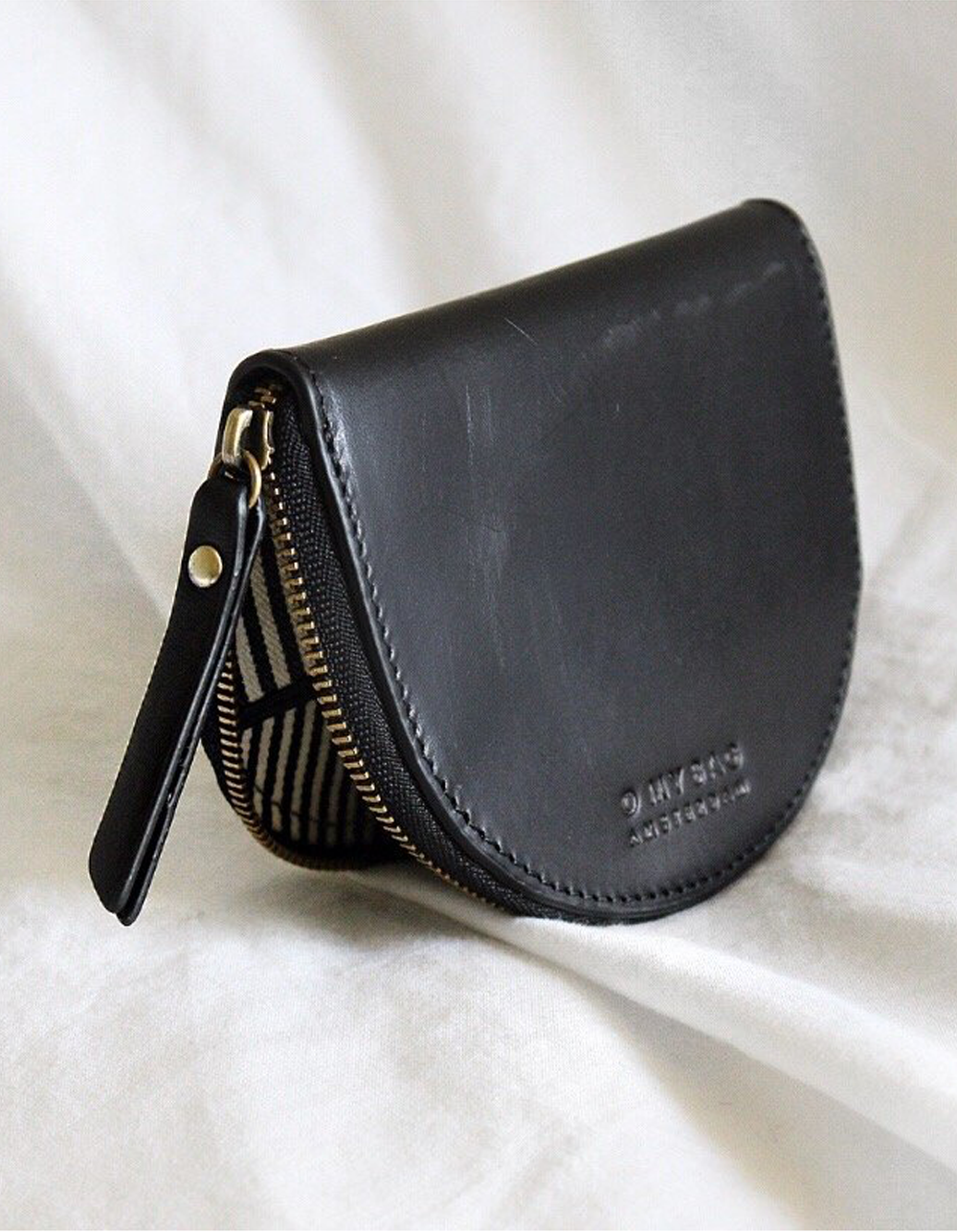 Small Black leather coin purse. Lifestyle image