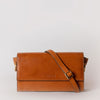Stella in cognac classic leather with adjustable leather strap. Front product image.