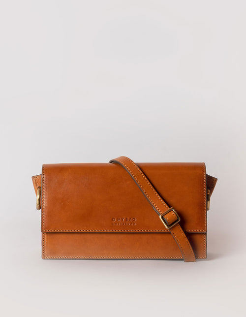 Stella in cognac classic leather with adjustable leather strap. Front product image.