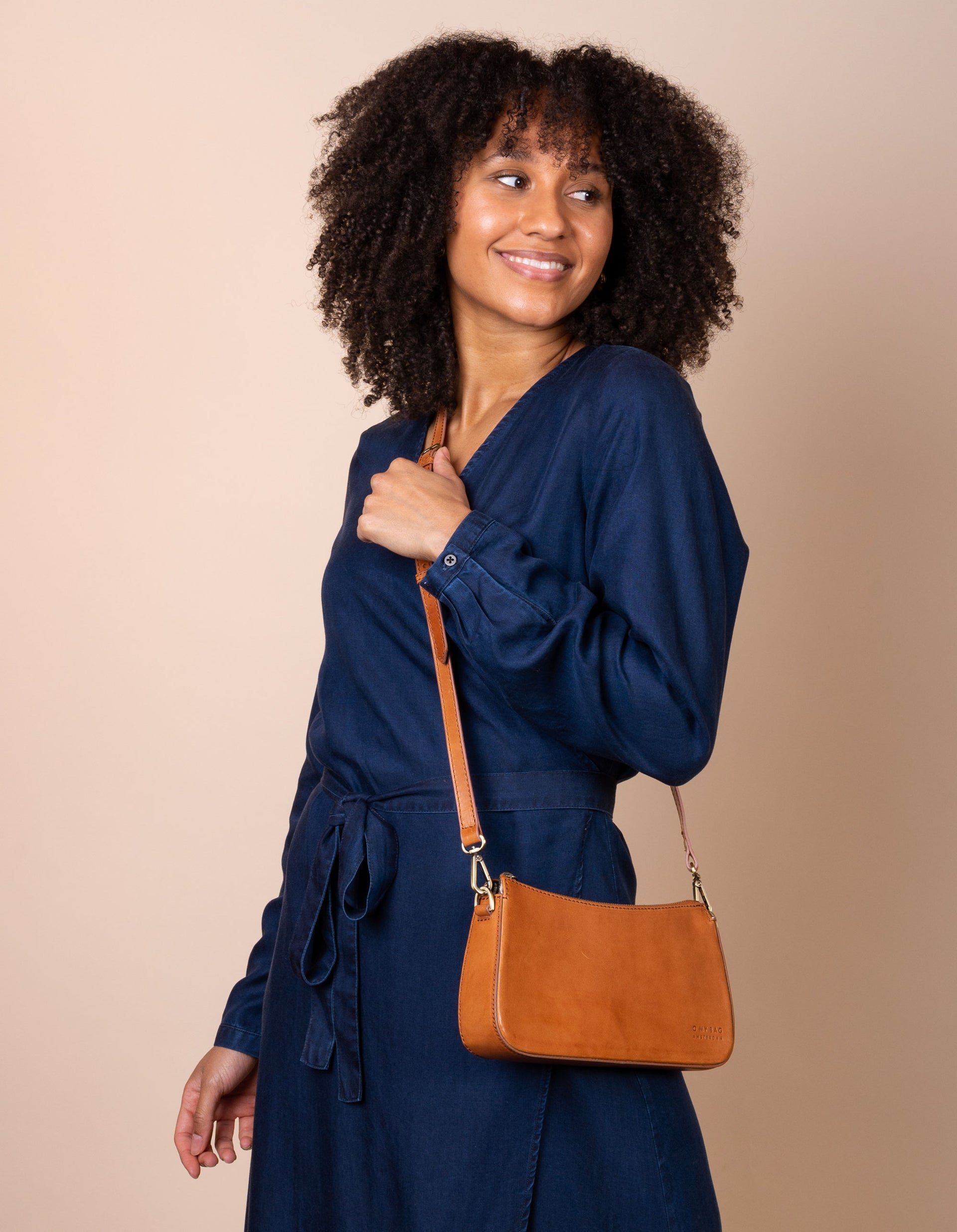 Taylor baguette bag in cognac - model product image with a long strap