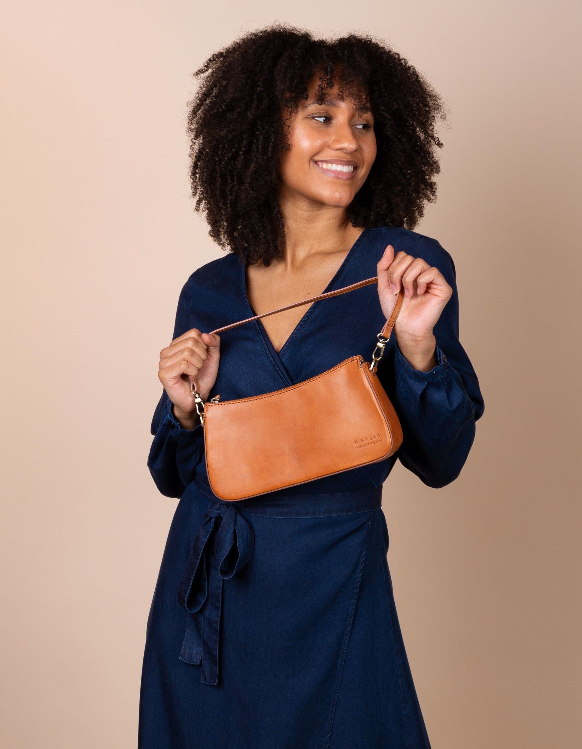 Taylor baguette bag in cognac - model product image with a short strap