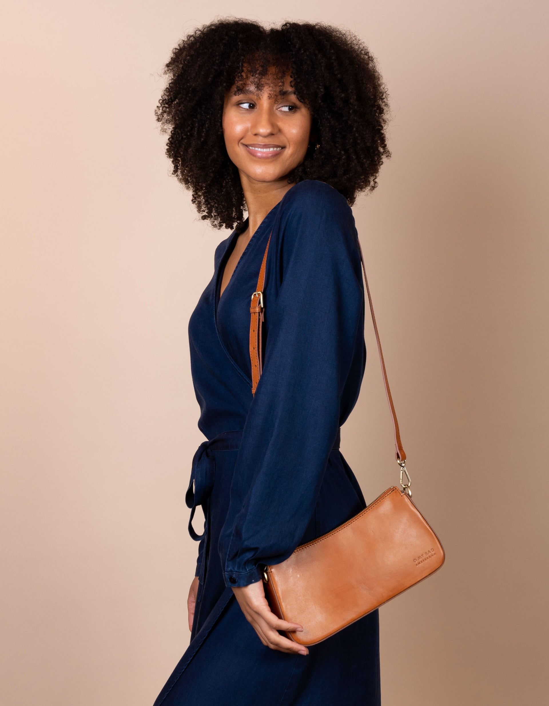 Taylor baguette bag in cognac - model product image with a long strap