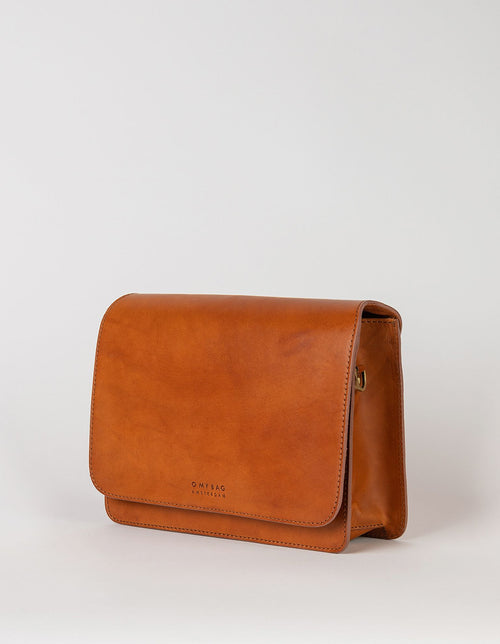 Audrey crossbody bag in cognac classic leather. Side product image.