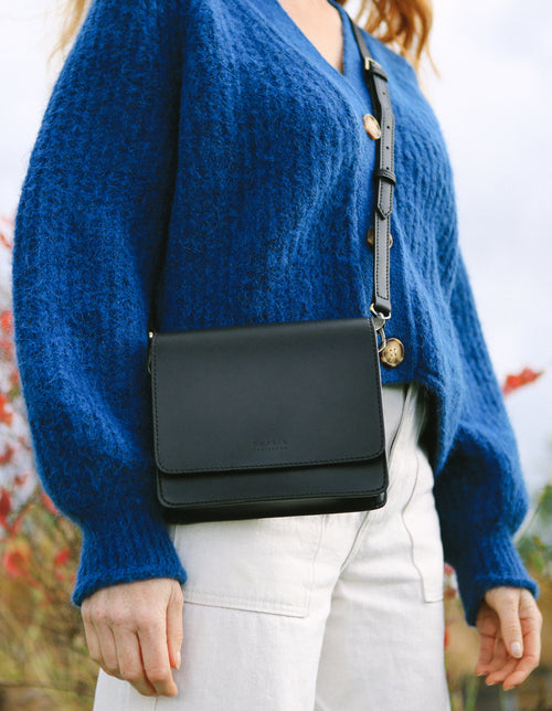 Audrey Mini Apple Vegan Leather Black Rectangle Ladies Handbag, Model Lifestyle image.