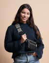 Black Leather womens fanny pack. Square shape with an adjustable strap. model product image
