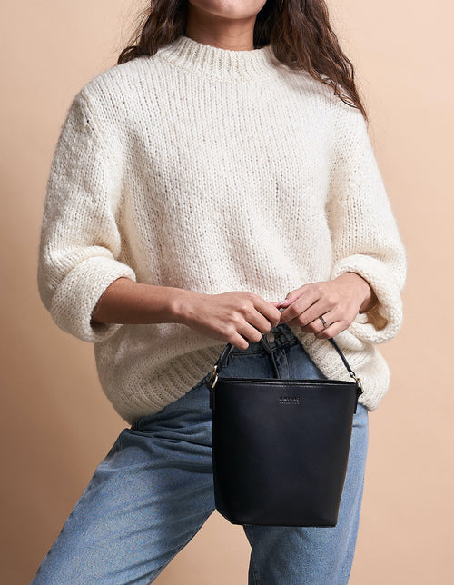 Small Black Bucket bag. Removable straps. Model product image