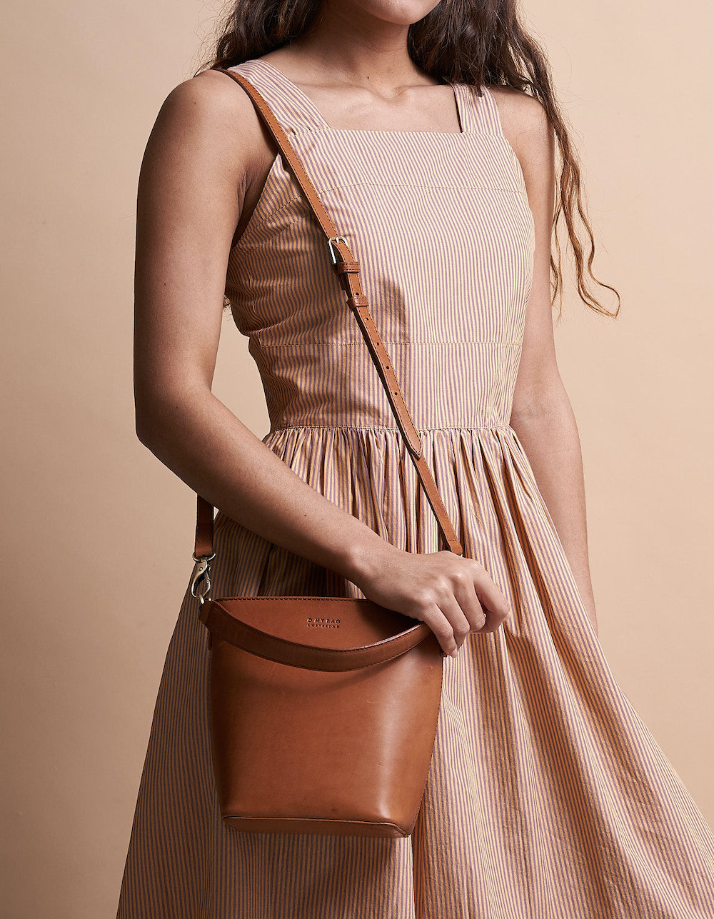 Small Cognac Bucket bag. Removable straps. Model product image