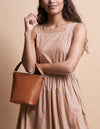 Small Cognac Bucket bag. Removable straps. Model product image